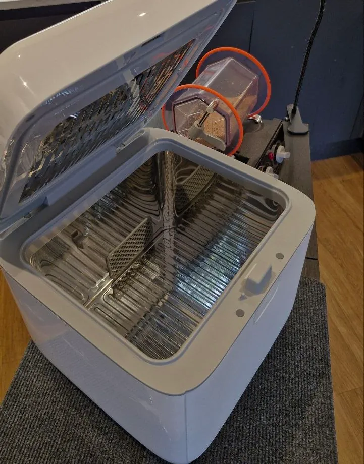 The open UV-C sanitisation cabinet with its reflective chamber, ready for cutlery